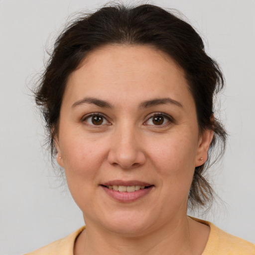 Joyful white adult female with medium  brown hair and brown eyes