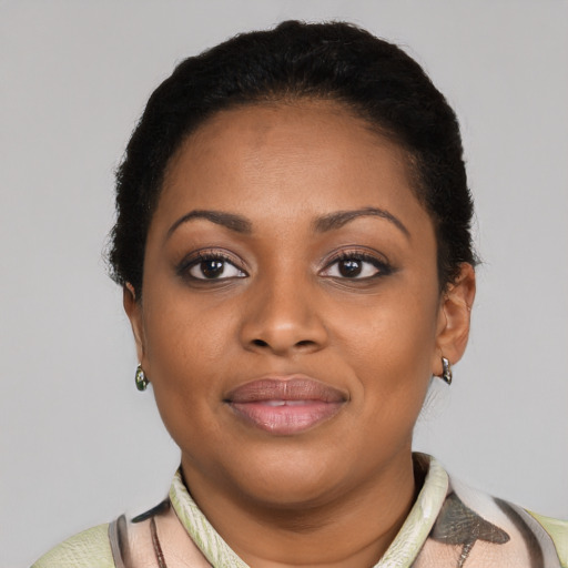 Joyful black young-adult female with short  brown hair and brown eyes