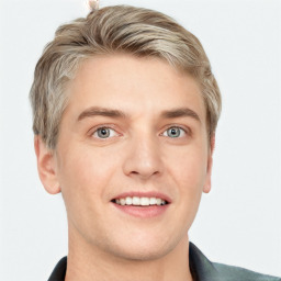 Joyful white young-adult male with short  brown hair and grey eyes