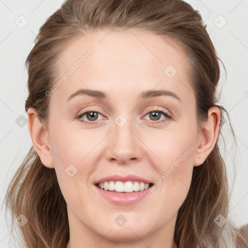 Joyful white young-adult female with long  brown hair and grey eyes