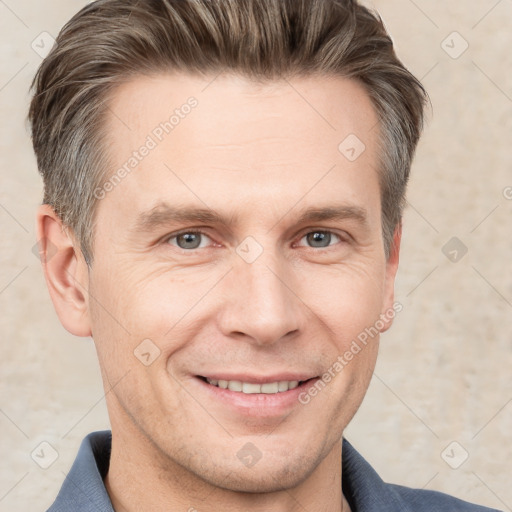 Joyful white adult male with short  brown hair and grey eyes