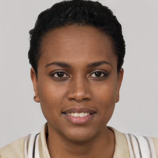 Joyful black young-adult female with short  brown hair and brown eyes