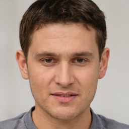 Joyful white young-adult male with short  brown hair and brown eyes