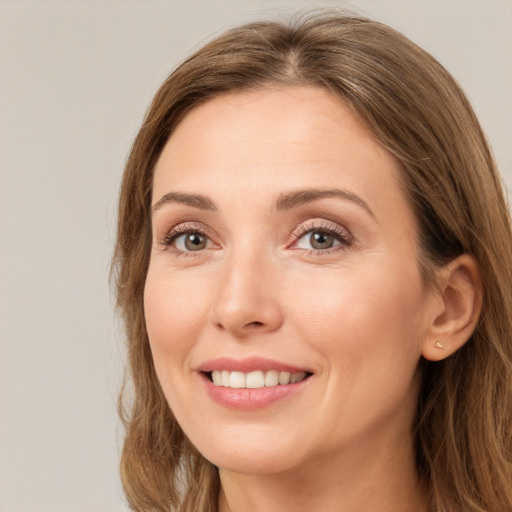 Joyful white young-adult female with long  brown hair and green eyes