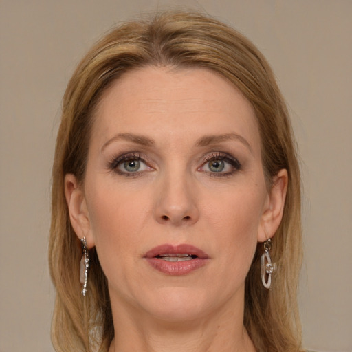 Joyful white adult female with long  brown hair and grey eyes