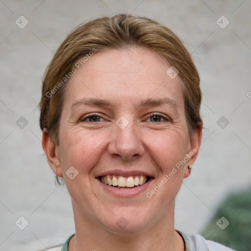 Joyful white adult female with short  brown hair and grey eyes