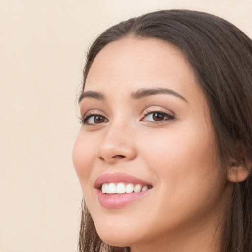 Joyful white young-adult female with long  brown hair and brown eyes