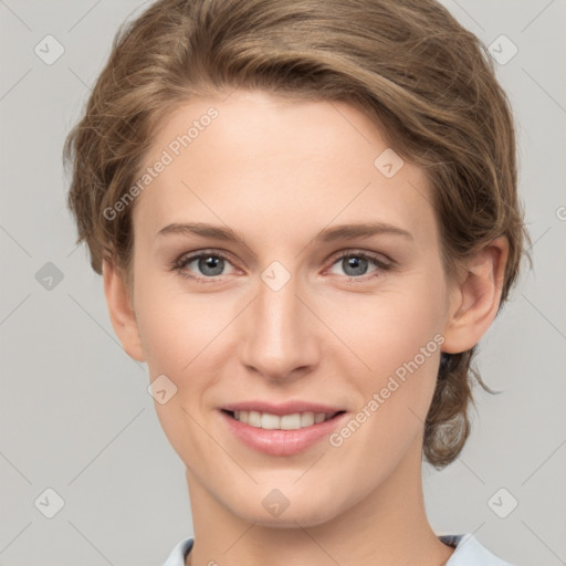 Joyful white young-adult female with short  brown hair and grey eyes