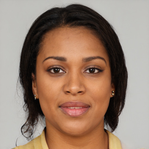 Joyful black young-adult female with medium  brown hair and brown eyes