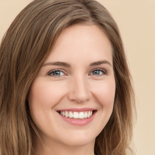 Joyful white young-adult female with long  brown hair and green eyes