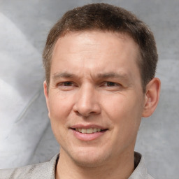 Joyful white adult male with short  brown hair and grey eyes