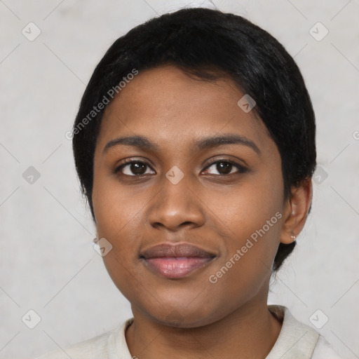 Joyful black young-adult female with short  black hair and brown eyes