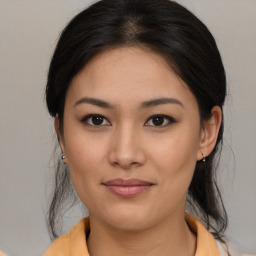 Joyful asian young-adult female with medium  brown hair and brown eyes