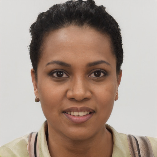 Joyful black young-adult female with short  brown hair and brown eyes