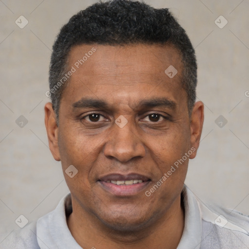 Joyful black adult male with short  black hair and brown eyes