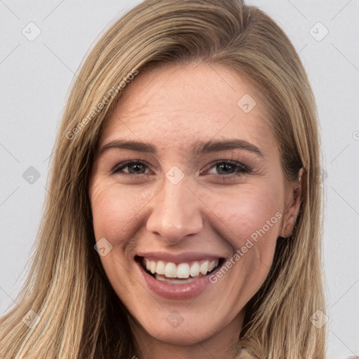 Joyful white young-adult female with long  brown hair and brown eyes