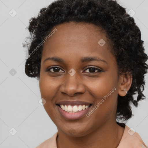 Joyful black young-adult female with long  brown hair and brown eyes