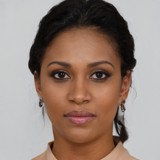 Joyful black young-adult female with long  black hair and brown eyes