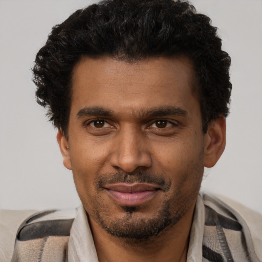 Joyful black adult male with short  brown hair and brown eyes