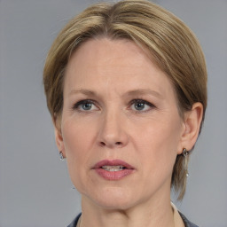 Joyful white adult female with medium  brown hair and grey eyes