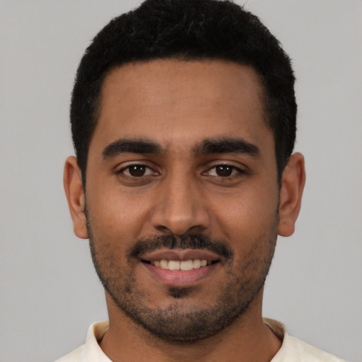 Joyful latino young-adult male with short  black hair and brown eyes