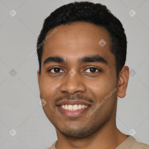 Joyful black young-adult male with short  black hair and brown eyes