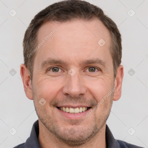 Joyful white adult male with short  brown hair and grey eyes