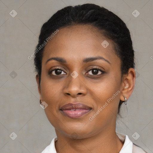 Joyful black young-adult female with short  black hair and brown eyes