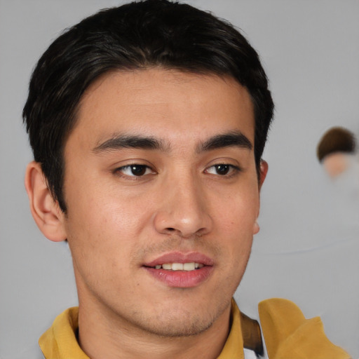 Joyful asian young-adult male with short  brown hair and brown eyes