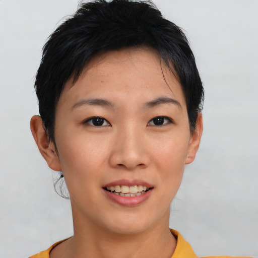 Joyful asian young-adult female with short  black hair and brown eyes