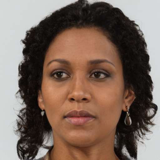 Neutral black adult female with long  brown hair and brown eyes