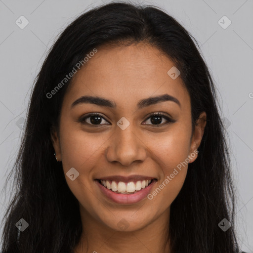 Joyful latino young-adult female with long  brown hair and brown eyes