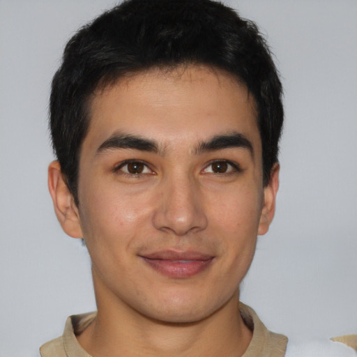 Joyful latino young-adult male with short  brown hair and brown eyes