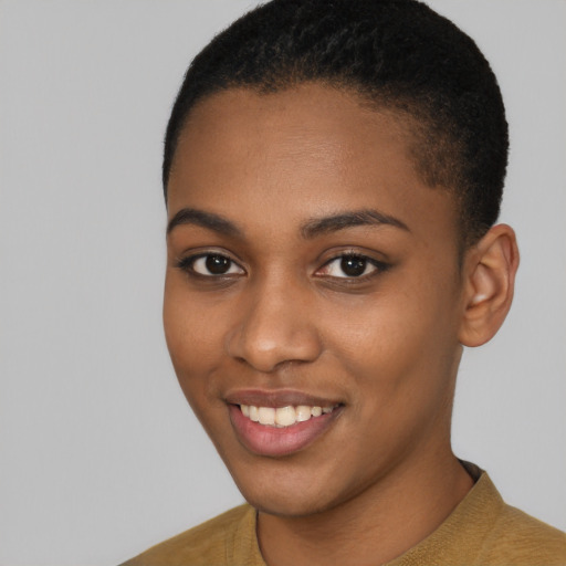 Joyful black young-adult female with short  brown hair and brown eyes