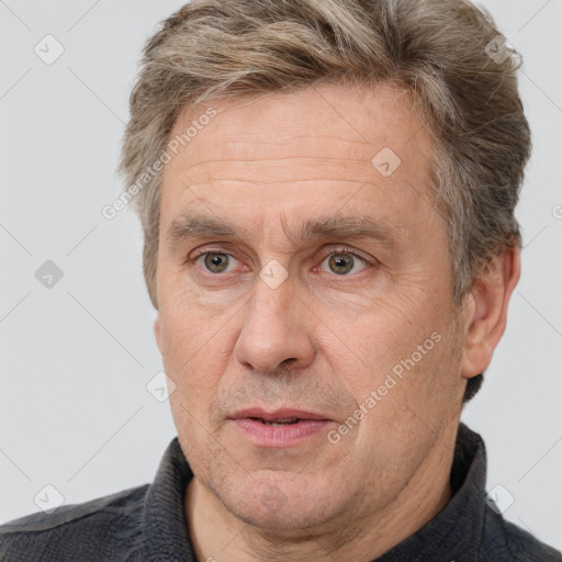 Joyful white middle-aged male with short  brown hair and brown eyes