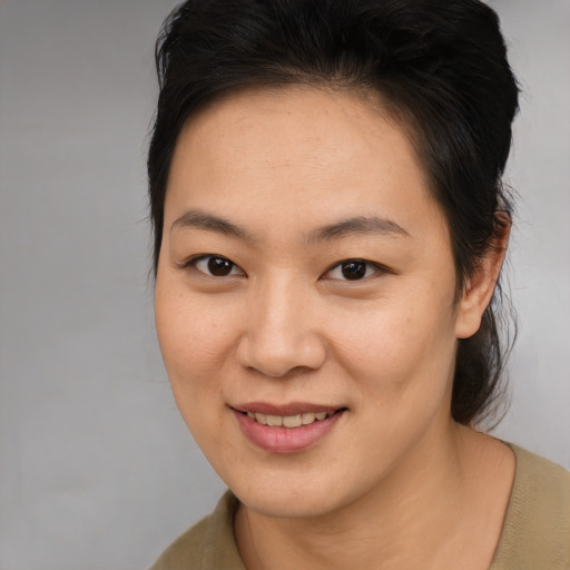 Joyful asian young-adult female with medium  brown hair and brown eyes
