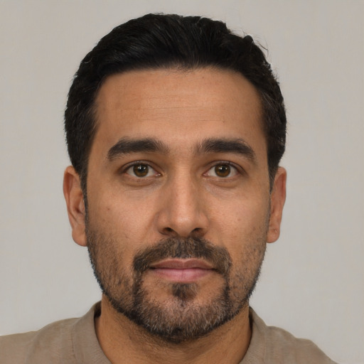 Neutral latino adult male with short  black hair and brown eyes