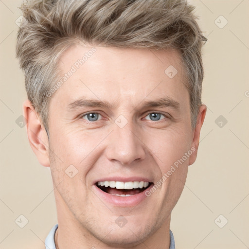 Joyful white adult male with short  brown hair and grey eyes