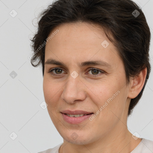 Joyful white adult female with short  brown hair and brown eyes