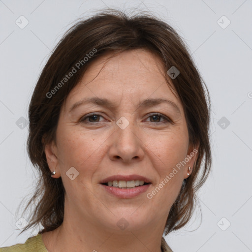 Joyful white adult female with medium  brown hair and brown eyes