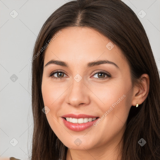 Joyful white young-adult female with long  brown hair and brown eyes