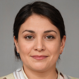 Joyful white adult female with medium  brown hair and brown eyes