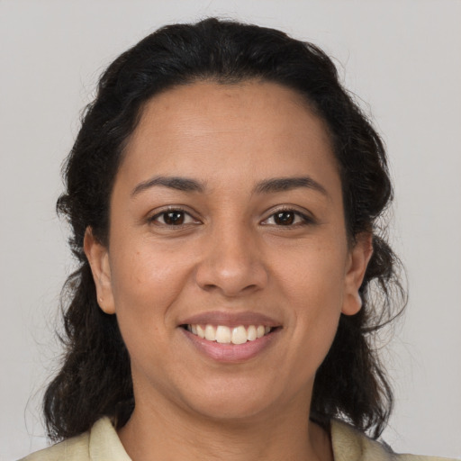 Joyful latino young-adult female with medium  brown hair and brown eyes