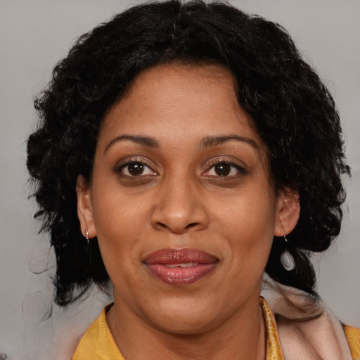 Joyful black adult female with medium  brown hair and brown eyes