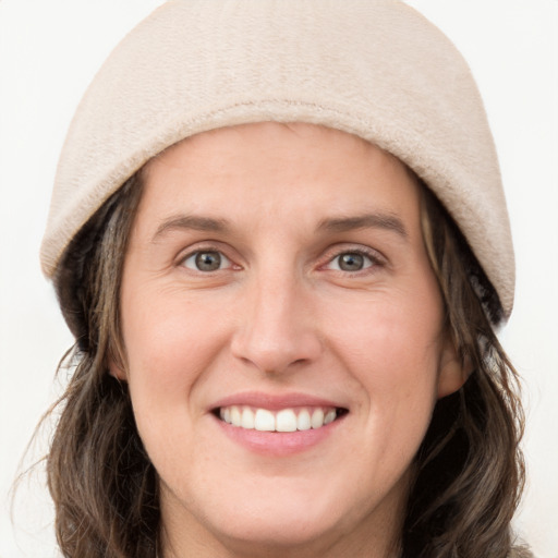 Joyful white young-adult female with medium  brown hair and blue eyes