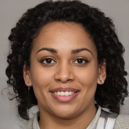 Joyful latino young-adult female with medium  black hair and brown eyes