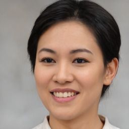 Joyful asian young-adult female with medium  brown hair and brown eyes