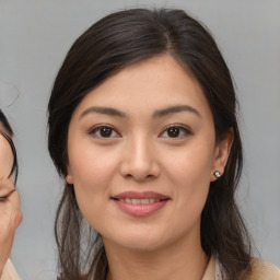 Joyful latino young-adult female with medium  brown hair and brown eyes