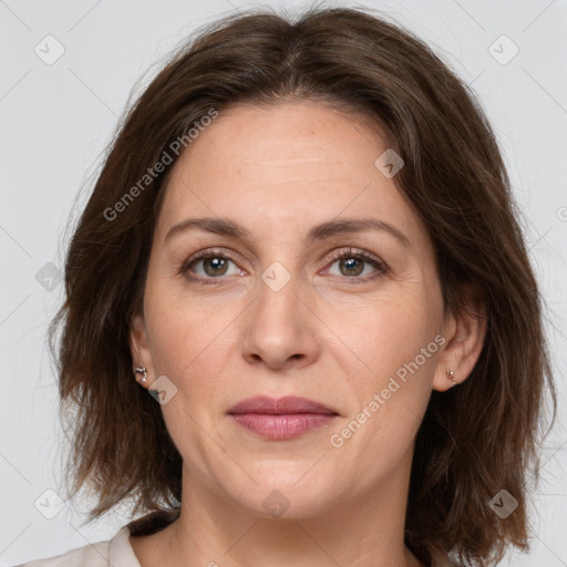 Joyful white adult female with medium  brown hair and grey eyes