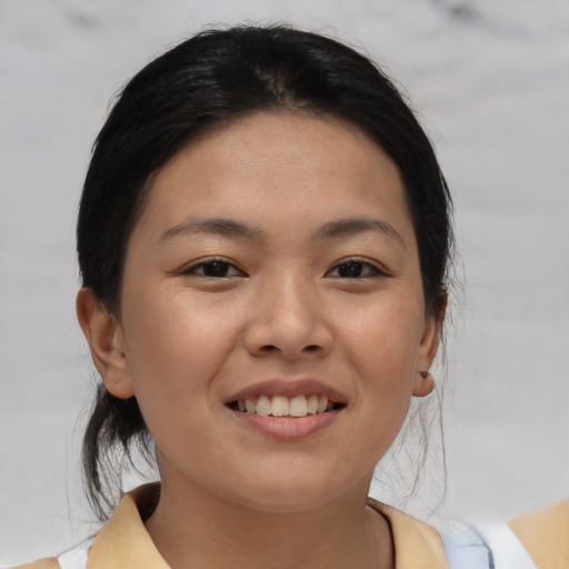 Joyful asian young-adult female with medium  brown hair and brown eyes